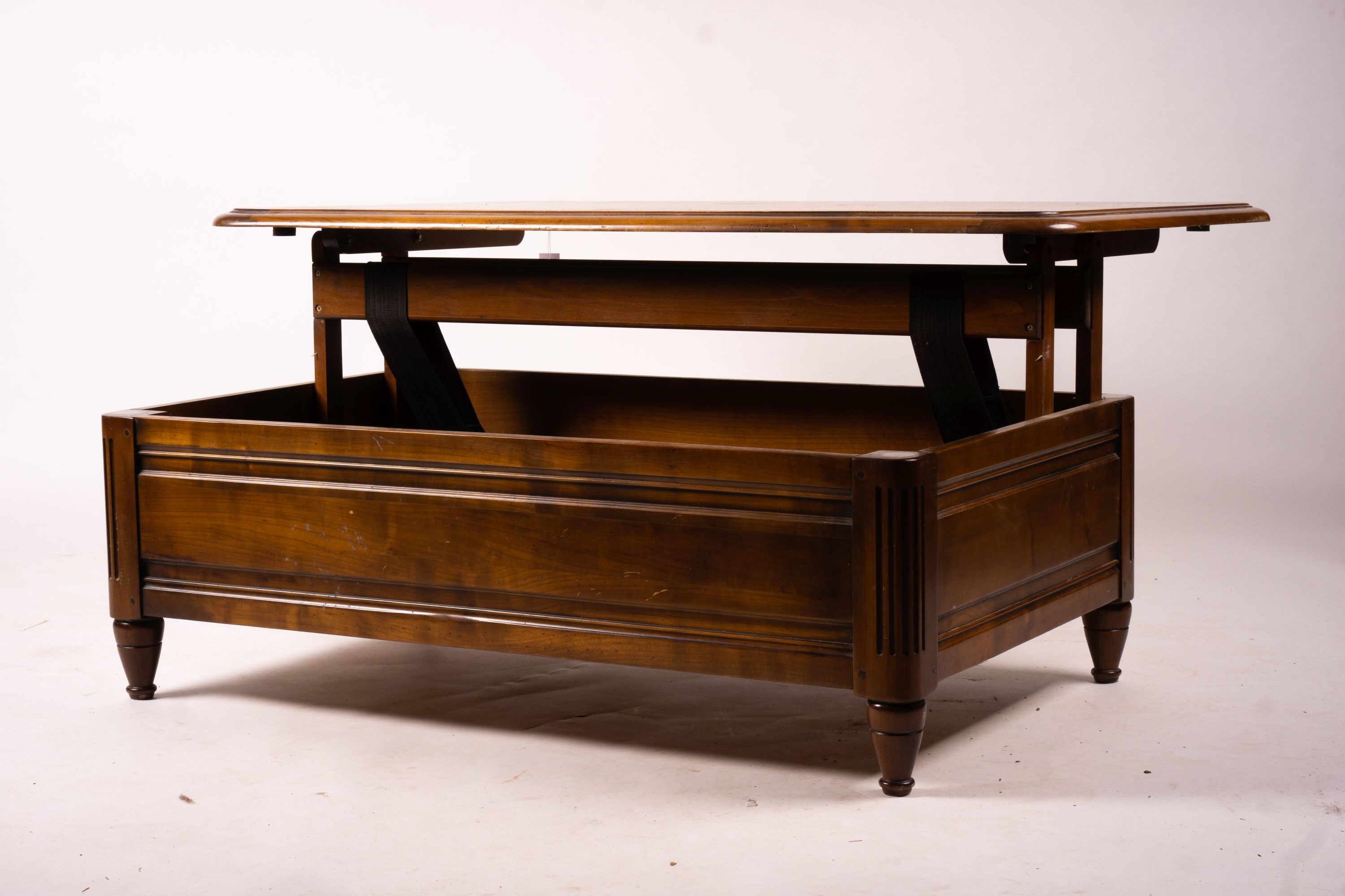 A reproduction rectangular walnut coffee table with rising top enclosing a wine bottle storage interior, length 130cm, depth 85cm, height 41cm